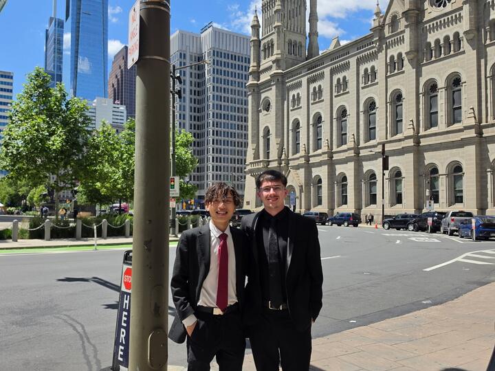 Two Lorem, Inc team members in suits on a city trip