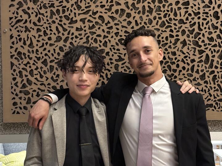Two Lorem, Inc team members in business attire at an event