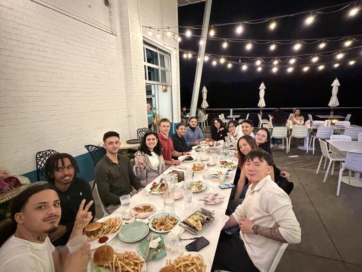 Lorem, Inc team dinner on a restaurant patio under string lights