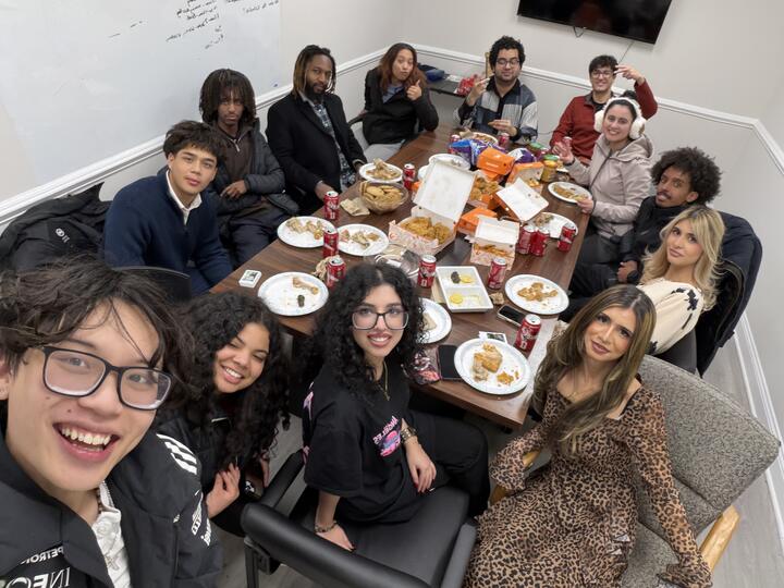 Lorem, Inc team sharing a meal around the office conference table